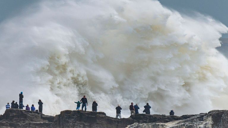 Waves crash against the harbour wall in Porthcawl, Wales