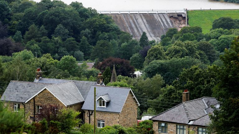 The damage of a dam is seen after a nearby reservoir was affected by flooding, in Whaley Bridge