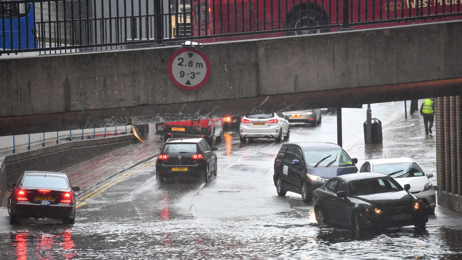 UK weather: Roads flooded and trains cancelled as heavy rain hits ...