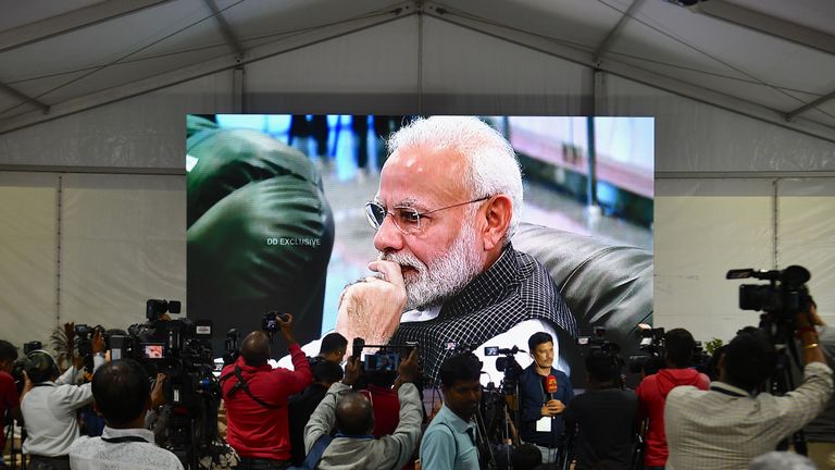 Members of the media cover the development as India's Prime Minister Narendra Modi is seen on a tv screen as he watches the live broadcast of the soft landing of spacecraft Vikram Lander of Chandrayaan-2 on the surface of the Moon at ISRO Telemetry, Tracking and Command Network (ISTRAC) centre in Bangalore early on September 7, 2019. - India lost communication with its unmanned spacecraft on September 7 just before it was due to land on the Moon, in a major setback to the country's lunar ambitions amid renewed interest in Earth's satellite. (Photo by Manjunath Kiran / AFP)        (Photo credit should read MANJUNATH KIRAN/AFP/Getty Images)