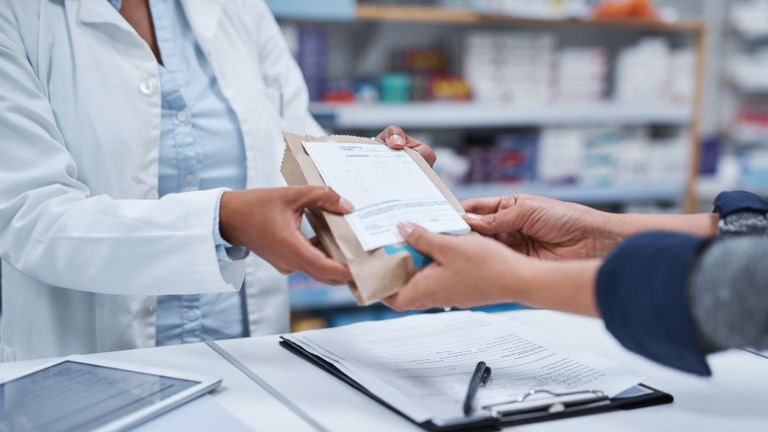 Closeup shot of an unrecognizable pharmacist assisting a customer in a chemist