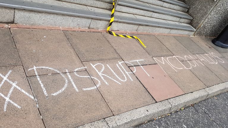 A pavement which has been grafittied with the words 'Disrupt McDonald's' outside Brighton Magistrates??? Court today, as a vegan activist is standing trial after protesters entered a McDonald???s restaurant wearing pig and chicken masks and red ???blood??? was thrown around.