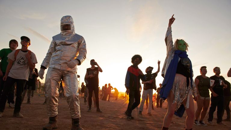 Attendees dance to music during Alienstock festival on the "Extraterrestrial Highway in Rachel, Nevada on September. 20, 2019. - A joke Facebook event named "Storm Area 51, They Can't Stop All of Us," was created in June 2019. As of September 13, more than 2 million people had signed up for the event and a 1.5 million more had marked themselves as "interested." Multiple alien related events are now set to take place over the weekend of September 20, 2019 along state Route 375 also known as the "Extraterrestrial Highway." (Photo by Bridget BENNETT / AFP)        (Photo credit should read BRIDGET BENNETT/AFP/Getty Images)