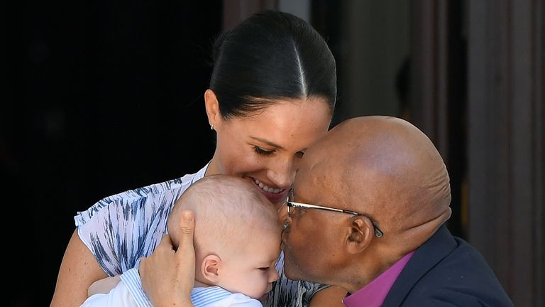 Baby Archie is kissed on the forehead by Archbishop Desmond Tutu while in the hands of his mother The Duchess of Sussex in cape Town, on day three of their tour of Africa.
