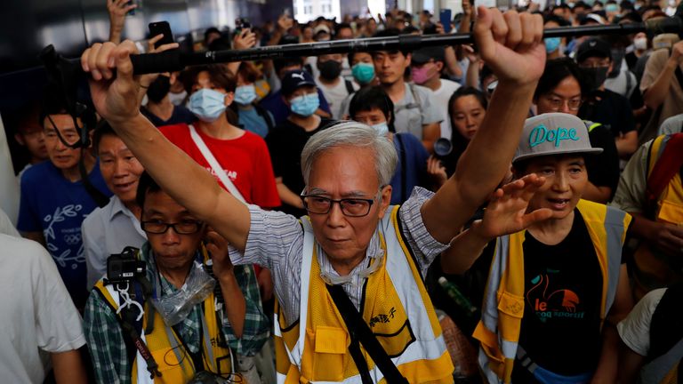 A man tries to block riot police during a protest in Tung Chung station