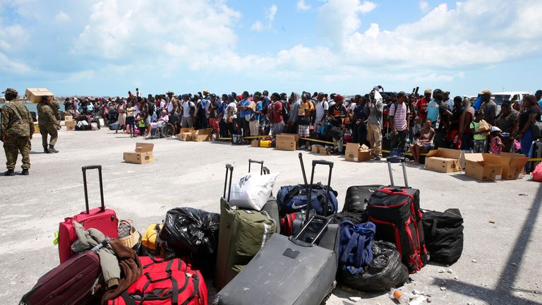 People wait to evacuated in private boats at the Marsh Harbour Port in hurricane devastated Grand Abaco Island on September 6, 2019