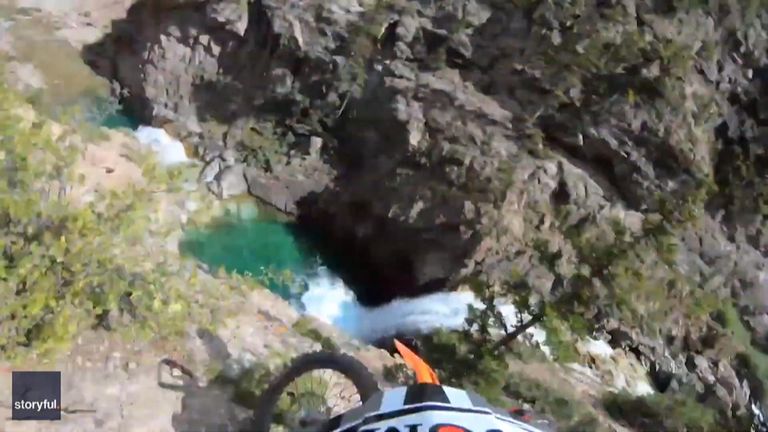 A motorcyclist survived a fall from a cliff into water, capturing the entire incident via a camera attached to his helmet