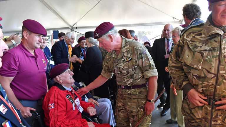 Prince Charles talks to former paratrooper Sandy Cortmann, 97, following his jump