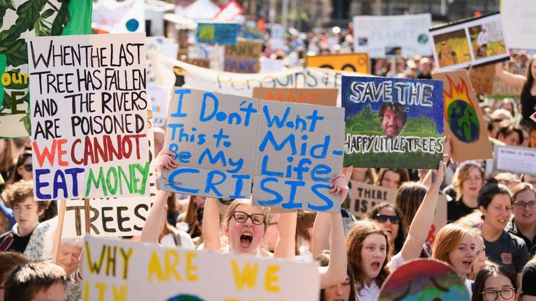 Students hold placards during a strike to raise climate change awareness at Cathedral Square in Christchurch, New Zealand