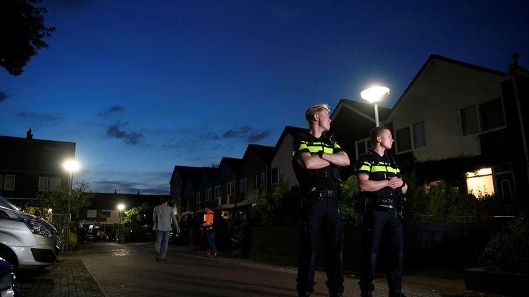 Police officers stand the scene of the shooting in Dordrecht