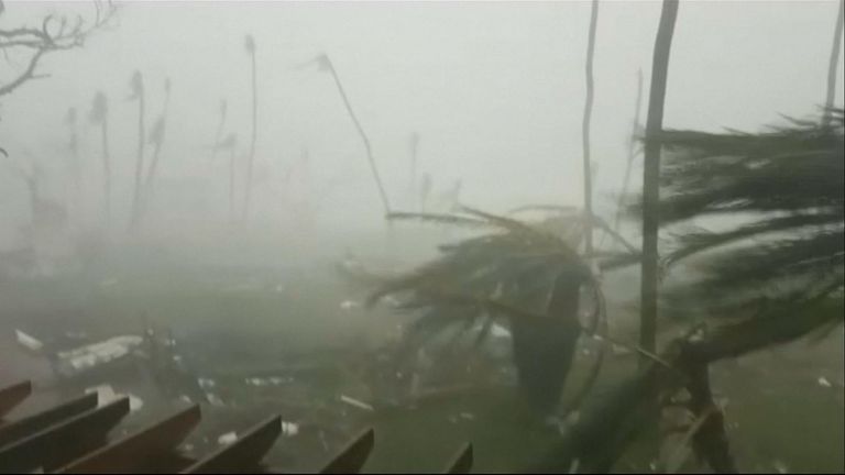 The power of Hurricane Dorian is shown striking Abaco Island in The Bahamas with furious rain beating down and palm trees bending under the heavy winds.