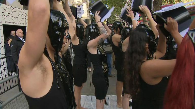 Activists poured black liquid on themselves in protest against the fashion industry using leather