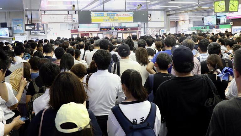 Commuters wait at a Japan Railways station for the resumption of trains operation after they were suspended due to typhoon Faxai in Saitama on September 9, 2019