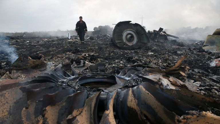 An Emergencies Ministry member walks at a site of a Malaysia Airlines Boeing 777 plane crash near the settlement of Grabovo in the Donetsk region, July 17, 2014
