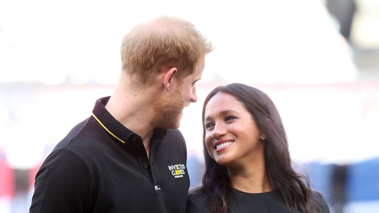LONDON, ENGLAND - JUNE 29: In this handout image provided by The Invictus Games Foundation, Prince Harry, Duke of Sussex and Meghan, Duchess of Sussex prepare to watch the first pitch as they attend the Boston Red Sox against the New York Yankees match at the London Stadium on June 29, 2019 in London, England. The historic two-game "You Just Cant Beat The Person Who Never Gives Up" series marks the sports first games ever played in Europe and The Invictus Games Foundation has been selected as 