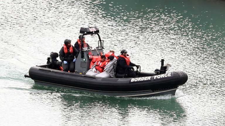 Migrants are brought to shore by Border Force officers at the Port of Dover in Kent