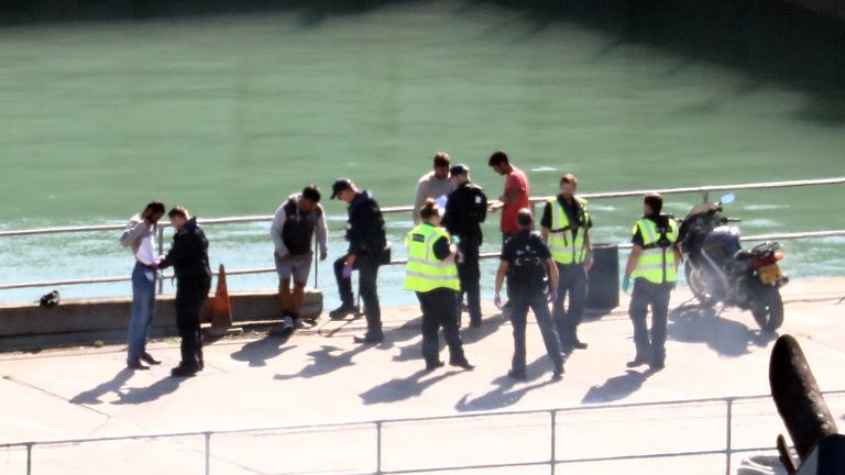 A group of men thought to be migrants are checked by Border Force officers in Dover