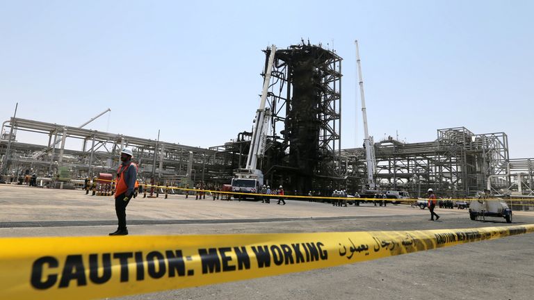 Workers at the damaged site of Saudi Aramco oil facility in Khurais, Saudi Arabia