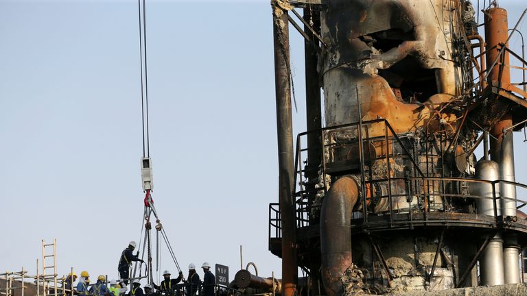 Workers at the damaged site of Saudi Aramco oil facility in Abqaiq