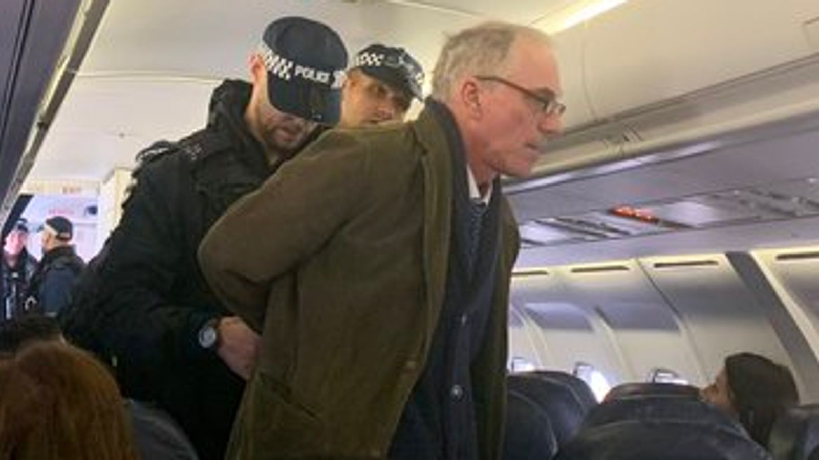 Flight returns to London City Airport terminal as climate change protester is arrested on board - Sky News