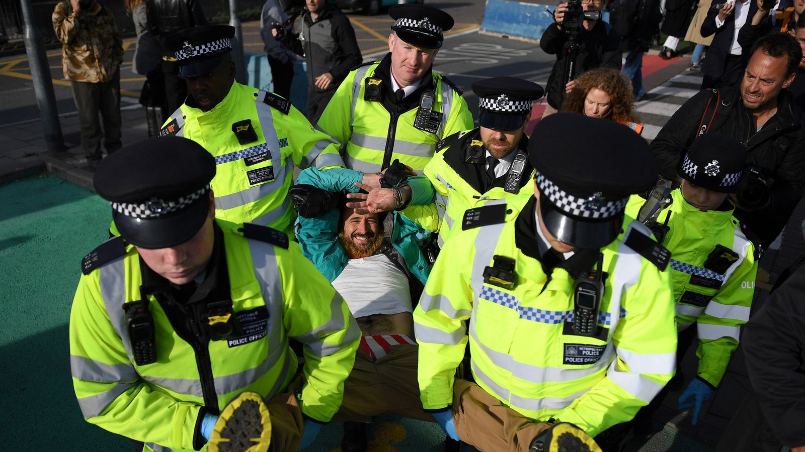 Extinction Rebellion protester climbs on plane at London City Airport ...