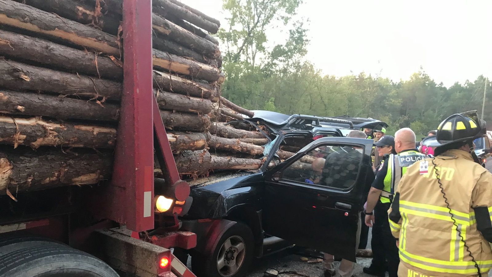 Man miraculously survives his car being impaled by logs from a truck