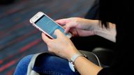 DALLAS, TX - SEPTEMBER 21, 2017: A woman uses her smartphone while waiting to board a plane at the Dallas/Fort Worth International Airport, located roughly halfway between Dallas and Fort Worth, Texas. (Photo by Robert Alexander/Getty Images)
