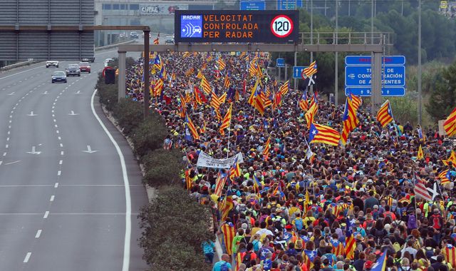 Protests paralyse Catalonia as fugitive ex-leader Puigdemont hands himself in