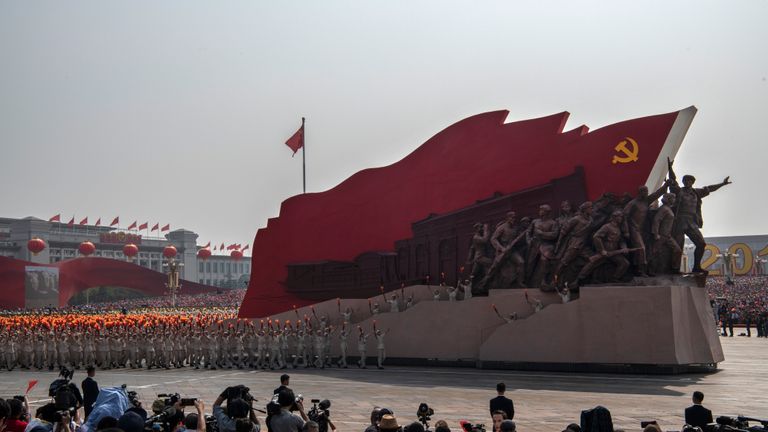 BEIJING, CHINA - OCTOBER 01: Chinese participants walk beside a Communist Party float at a parade to celebrate the 70th Anniversary of the founding of the People's Republic of China in 1949,  at Tiananmen Square on October 1, 2019 in Beijing, China. (Photo by Kevin Frayer/Getty Images)