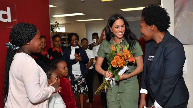 The Duchess of Sussex is presented flowers by Luyanda, eight , as she visits Action Aid, a gender based violence education club in Johannesburg, South Africa, on day nine of her tour of Africa.
