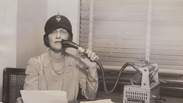 (Original Caption) Lady Astor, British parliamentarian, reading from a brief into a dictaphone device.