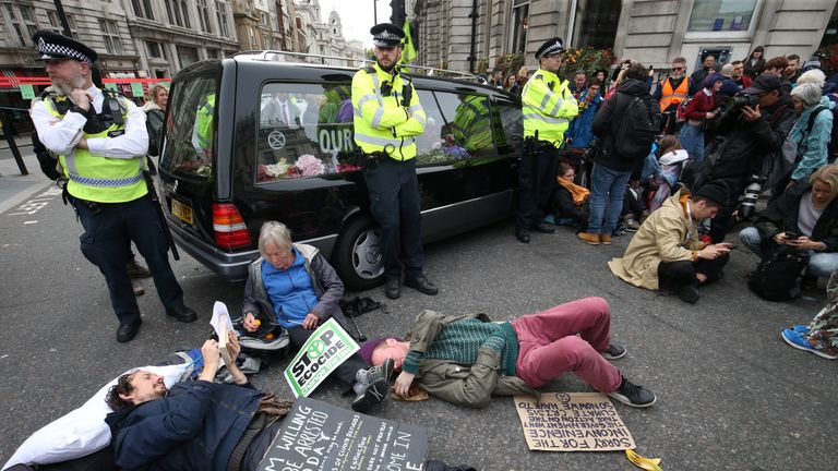 A hearse is used to block the road at the junction of Whitehall and Trafalgar Square during the Extinction Rebellion protest London.