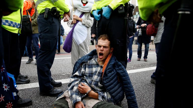 Ann activist in handcuffs shouts as he sits at Westminster Bridge during the Extinction Rebellion protest in London, Britain October 7, 2019. REUTERS/Henry Nicholls