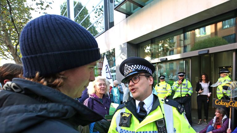 A member of the police discusses section 14 of the Public Order Act with protesters outside the Department for Environment, Food and Rural Affairs , Marsham Street, during an Extinction Rebellion (XR) protest in Westminster, London.