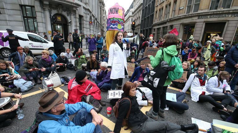 Scientists for Extinction Rebellion make a declaration at the junction of Moorgate and Lothbury, behind the Bank of England in the City of London, during an XR climate change protest.