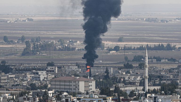 This picture taken on October 18, 2019 from the Turkish side of the border at Ceylanpinar district in Sanliurfa shows fire and smoke rising from the Syrian town of Ras al-Ain on the first week of Turkey's military operation against Kurdish forces. - Sporadic clashes between Turkish forces and Kurdish groups were ongoing in a battleground Syrian border town on October 18, a monitor said, despite Ankara's announcement of a five-day truce. (Photo by Ozan KOSE / AFP) (Photo by OZAN KOSE/AFP via Getty Images)