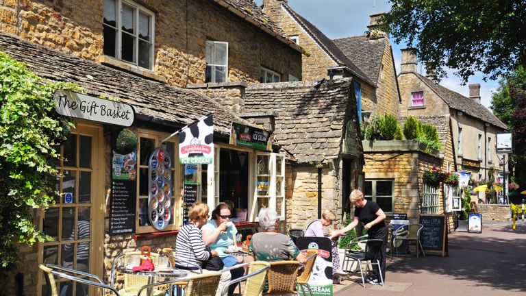 Bourton on the Water, United Kingdom - June 12, 2014:  Women relaxing at a pavement cafe with waitress service, Bourton on the Water, Gloucestershire, England, UK, Western Europe.