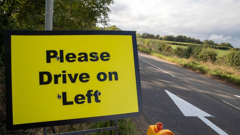 Please drive left signs and arrows have been placed on the B4031 road outside RAF Croughton, Northamptonshire, where 19-year-old Harry Dunn died when his motorbike was involved in a head-on collision in August.