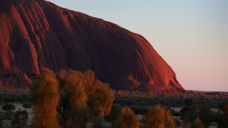 ULURU, AUSTRALIA - AUGUST 14: A general view of Uluru as seen from the designated sunrise viewing area at Uluru on August 14, 2019 in the Uluru-Kata Tjuta National Park, Australia. The Uluru-Kata Tjuta National Park board decided unanimously that the climb will close permanently on October 26, 2019. The date coinciding with the hand-back to traditional owners in 1985 and seen by many as a form of reconciliation. The climb deadline date has sparked a considerable boost in tourism, also aided by cooler weather and the introduction of direct flights to Ayers Rock Airport from cities Da2rwin and Adelaide. According to Parks Australia Uluru has welcomed 244,075 visitors this calendar year, an increase of 18.7%. Sacred to the Yankunytjatjara and Pitjantjatjara people, climbing Uluru (also known as Ayers Rock) is strongly discouraged by them for its cultural significance and their concerns for peoples safety. Over 30 people have died and numerous injured while attempting the steep ascent, less than 20% of park visitors take part in the climb. Known as Anangu land, the arkose sandstone formation, 348 meters high is believed to be half a billion years old. The Uluru-Kata Tjuta National Park, jointly managed by Anangu traditional owners and Parks Australia includes Kata Tjuta (The Olgas) and is recognised by UNESCO as a World Heritage Area. (Photo by Lisa Maree Williams/Getty Images)