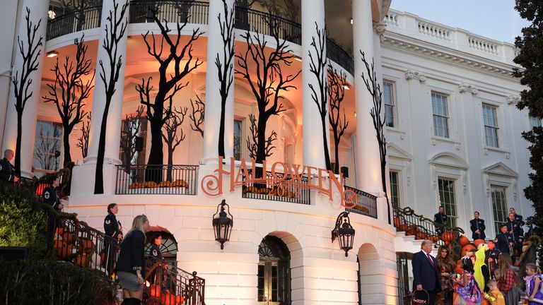 WASHINGTON, DC - OCTOBER 28:  U.S. President Donald Trump and first lady Melania Trump hand out candy to children as they trick-or-treat during a Halloween at the White House event at the South Portico of the White House October 28, 2019 in Washington, DC.  (Photo by Alex Wong/Getty Images)