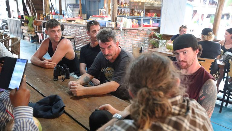 Phil Bambridge, centre, the father of missing backpacker Amelia Bambridge, sits with his family during a meeting with the governor of Koh Rong City Noun Bunthol