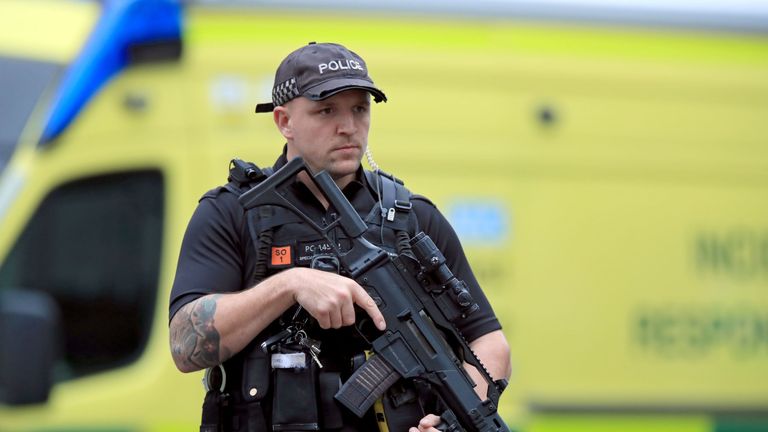 An armed police officer outside the Arndale Centre in Manchester 