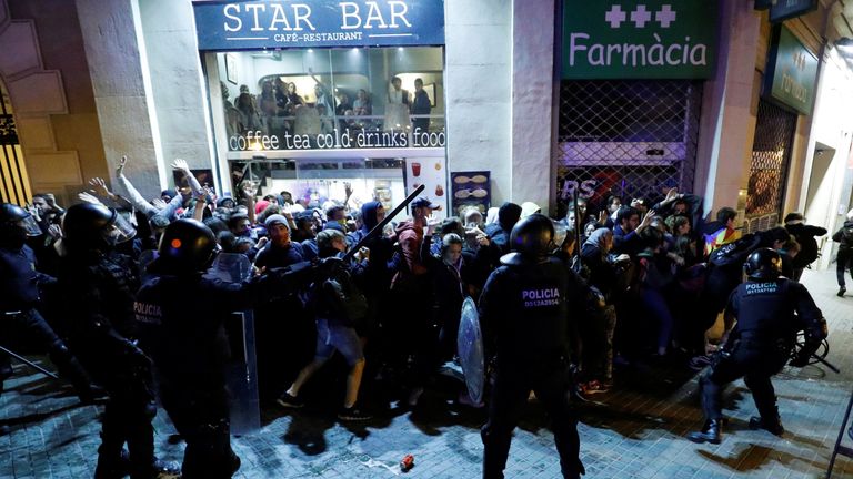 Police scuffle with protesters in the Catalan capital