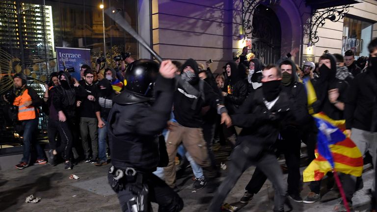 Police swing batons at protesters 