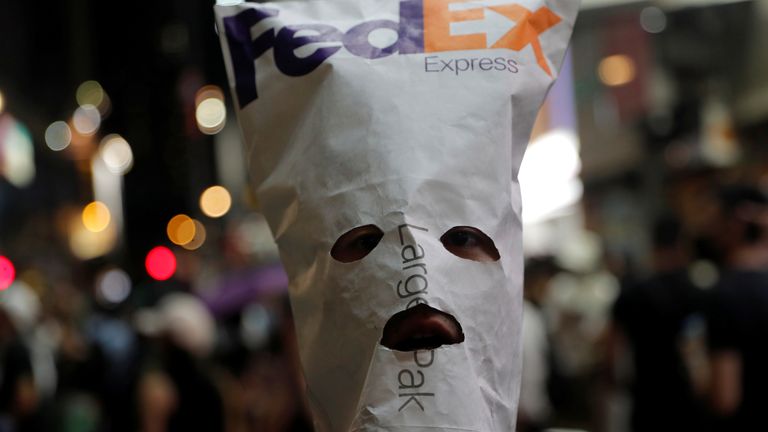 An anti-government protester wears a mask made with a FedEx envelope during a demonstration in Hong Kong, China