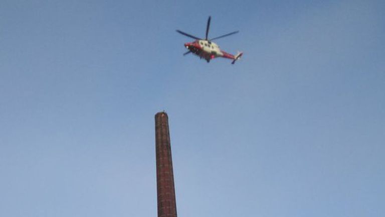 A man has been spotted at the top of Dixon's Chimney in Carlisle. Pics: Twitter/ Tim Graham