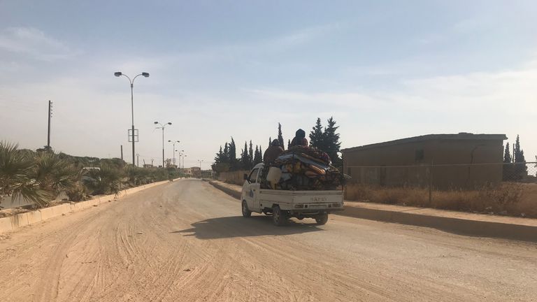 A family is seen leaving Derbasya on a truck