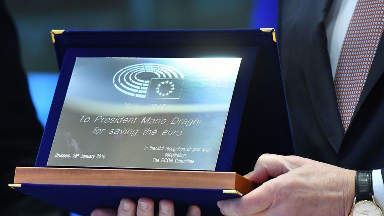 European Central Bank President Mario Draghi receives a gift from European Parliament members before addressing the committee on Economic and Monetary Affairs at the European Parliament in Brussels on January 28, 2019. (Photo by EMMANUEL DUNAND / AFP) (Photo credit should read EMMANUEL DUNAND/AFP/Getty Images)