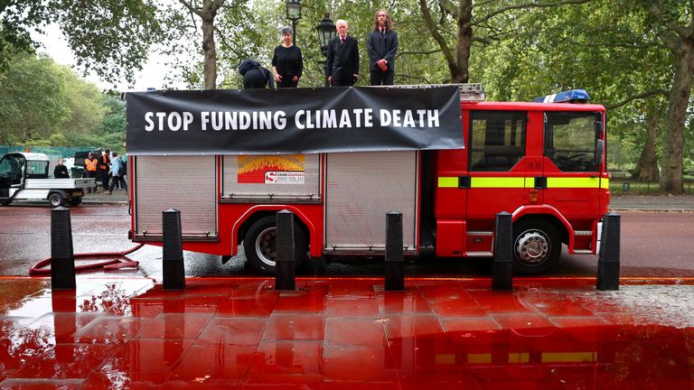 Extinction Rebellion protestors demonstrate outside the Treasury building in London