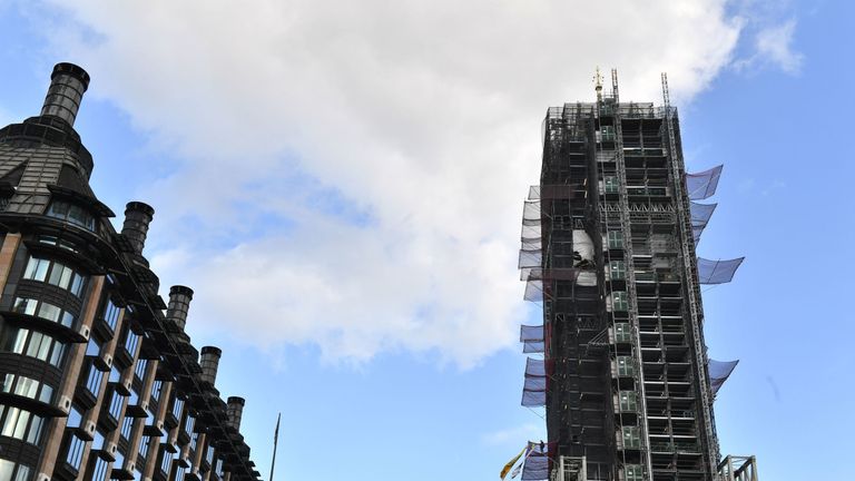 An Extinction Rebellion protester who has scaled the scaffolding surrounding Big Ben at the Houses of Parliament, Westminster, London.